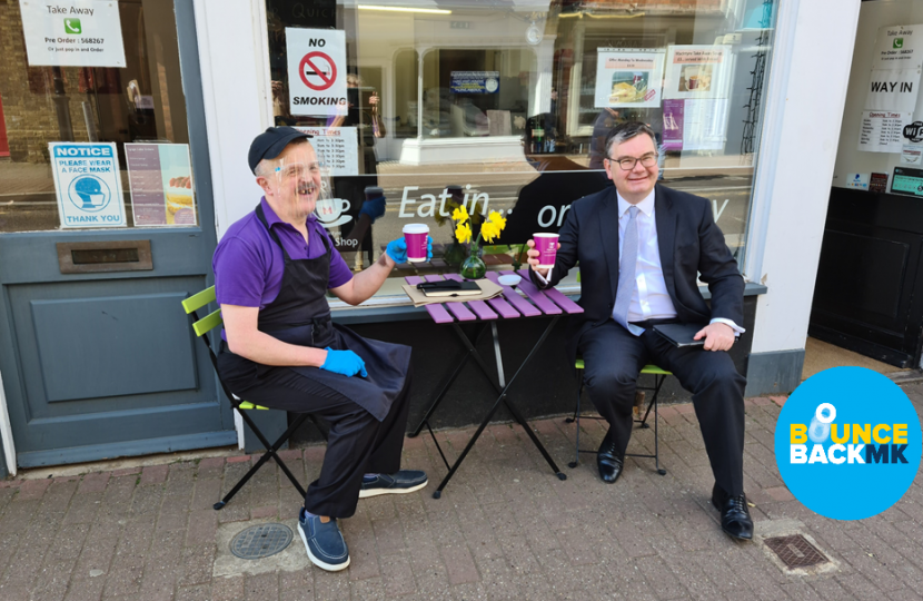 Iain Stewart MP outside MacIntyre Coffee Shop with a coffee