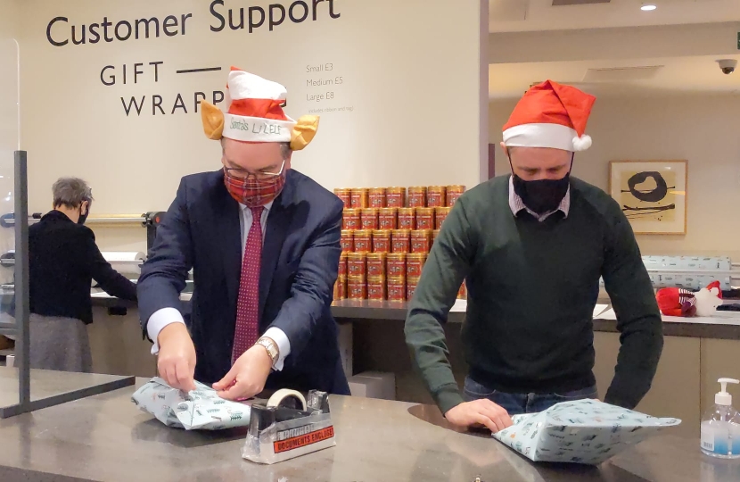 Iain wrapping presents with Ben Everitt MP