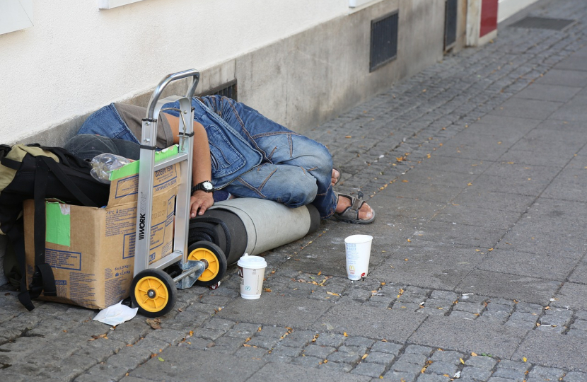 Homeless man sleeping on ground