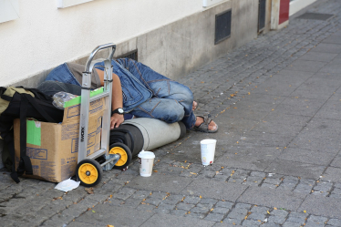 Homeless man sleeping on ground