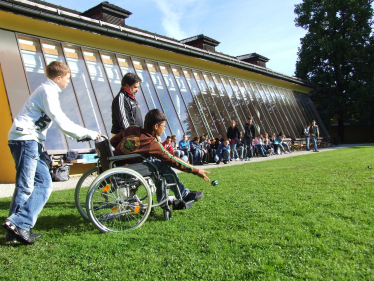 Child in a wheelchair playing at school